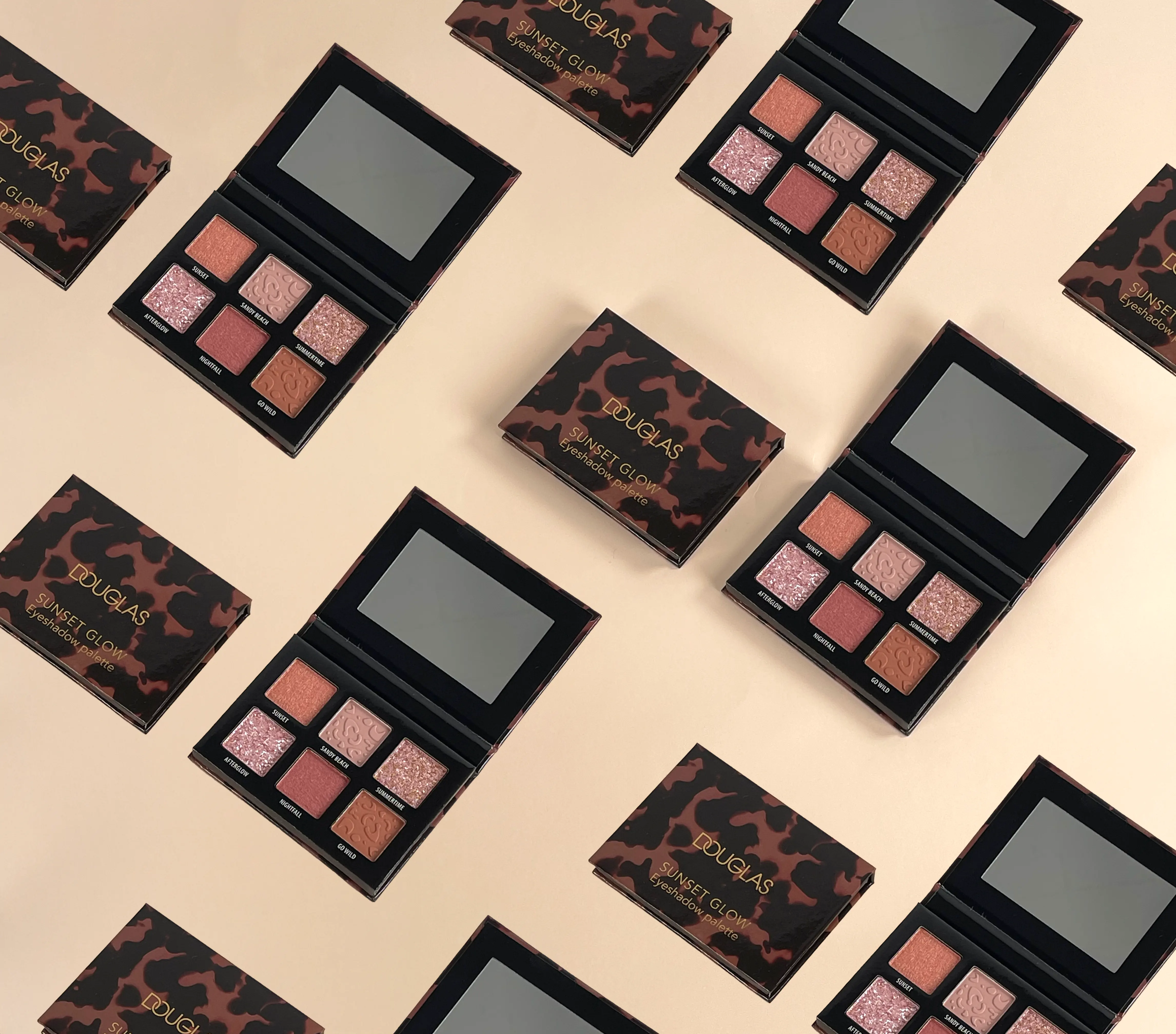 flat lay of Douglas- branded eyeshadow palettes, showcasing a variety of shades and textures