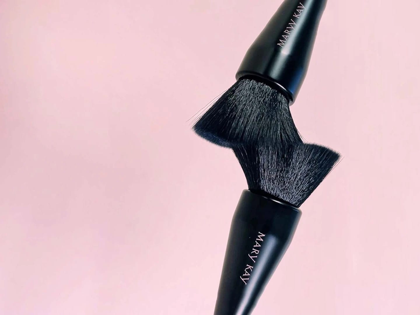 A close-up of a makeup brush set, showcasing Mary Kay products