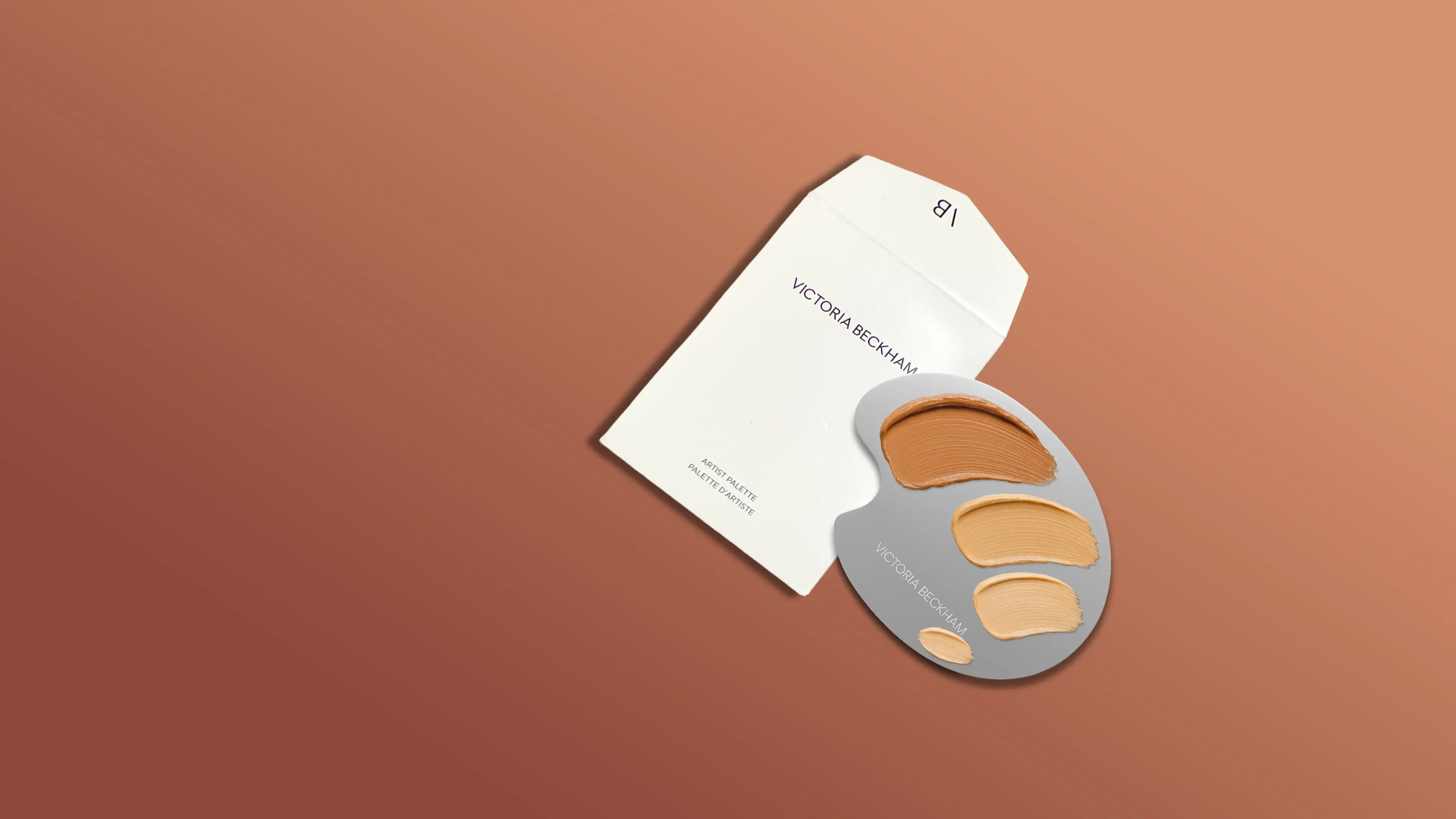 artist palette beside a white envelope labeled 'Victoria Beckham,' highlighting the brand's makeup artistry collection